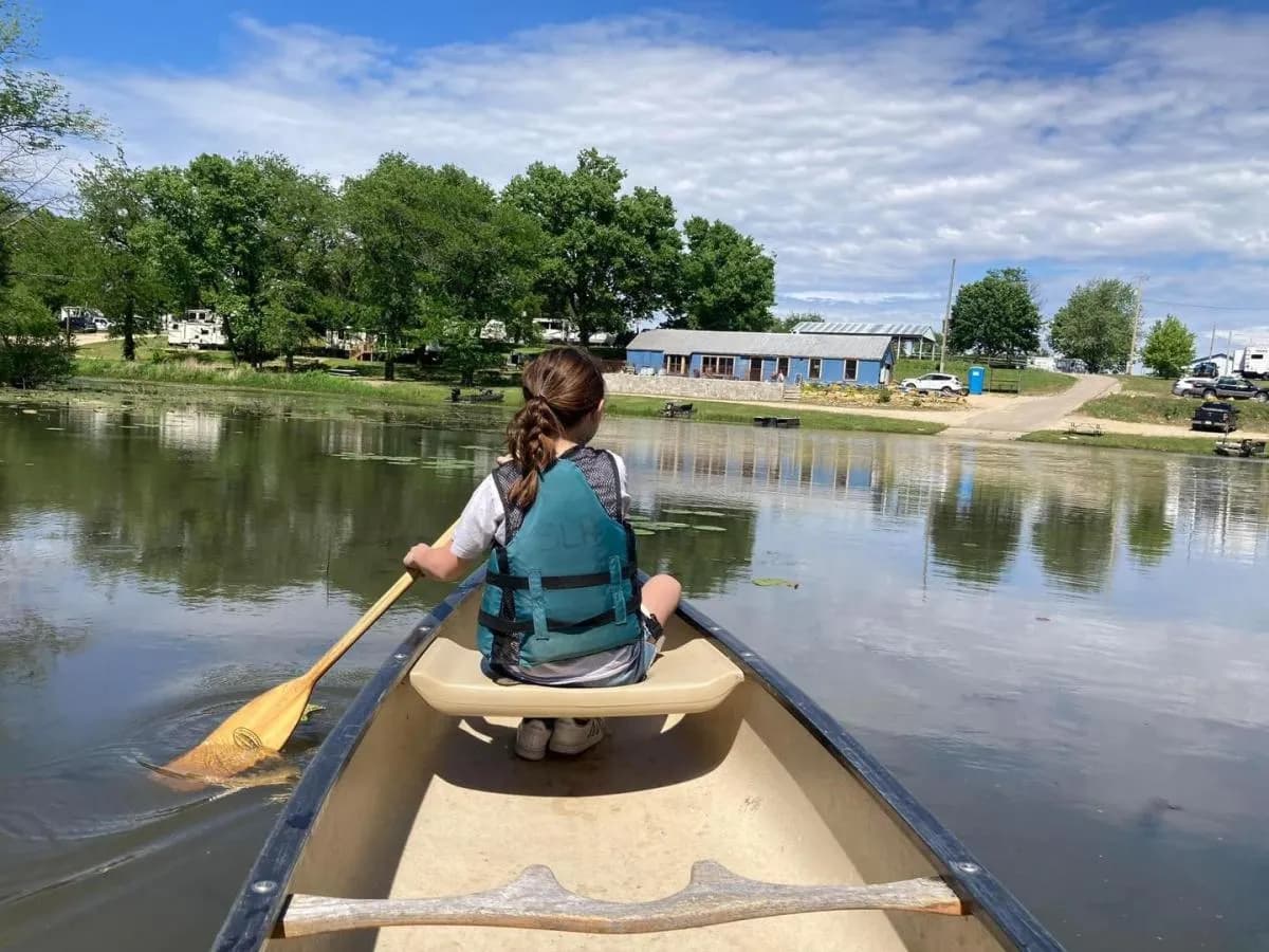 A paddler canoeing a quiet backwater in Northwest Illinois