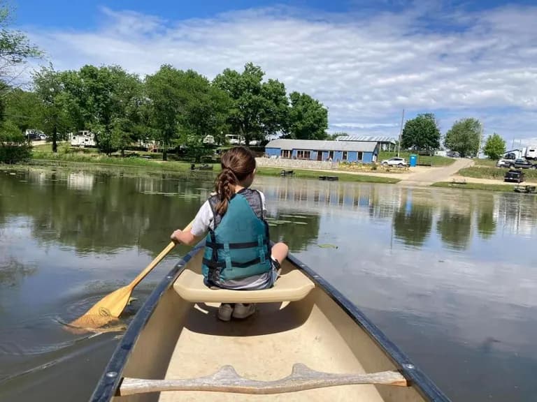 A paddler canoeing a quiet backwater — river recreation in Northwest Illinois